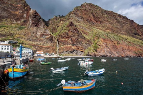Boat harbour with boats and cliffs