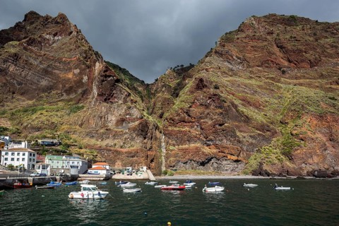 Boat harbour with boats and cliffs