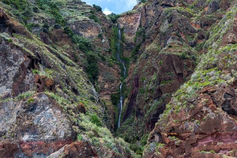Volcanic cliff with waterfall