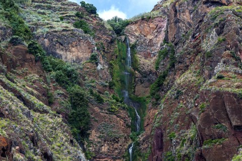 Volcanic cliff with waterfall