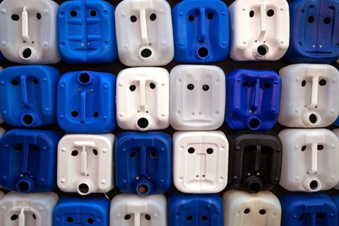 White and blue plastic canisters with faces