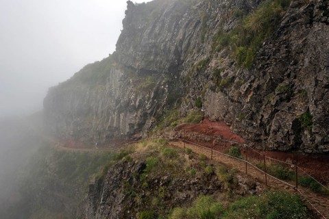 Hikers on the PR1 Vereda do Areeiro hiking trail in the fog