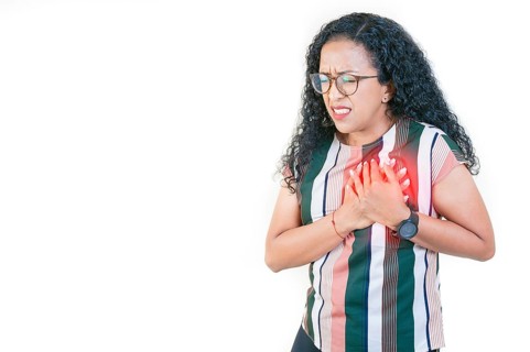 Afro girl with tachycardia touching chest. People with heart problems. Afro woman with heart pain touching chest isolated