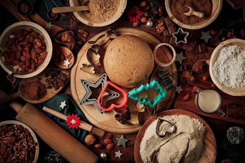 Dough ball and cookie cutters on a wooden board