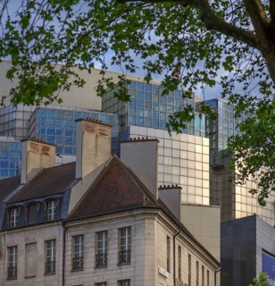 Historic houses in front of the modern Paris Opera