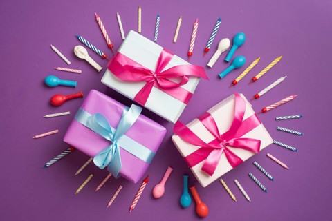 Gifts surrounded by candles balloons