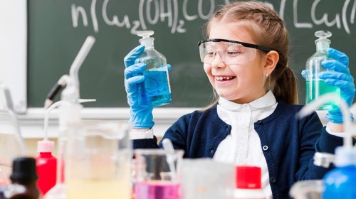 Happy girl with goggles holding flasks