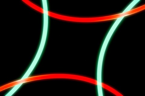 Illuminated red green curve lights black background