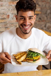 Medium shot man holding plate with food