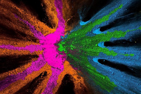 Mixed holi colors design black surface