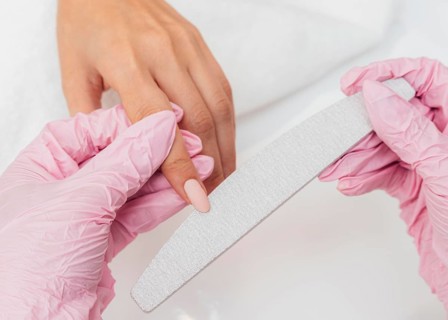Nail hygiene care beautician wearing gloves close up