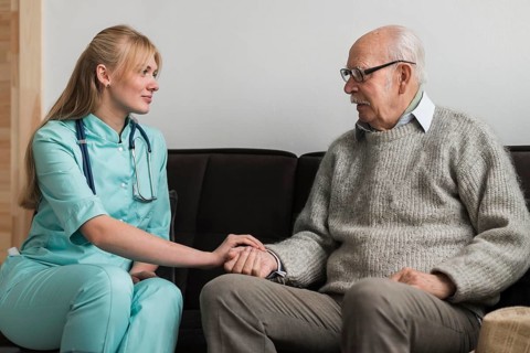Nurse holding old man s hand nursing home