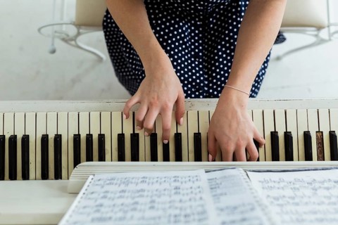 Overhead view woman s hand playing piano