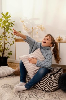 Portrait little girl home pointing