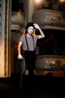 Portrait mime male artist posing with umbrella stage