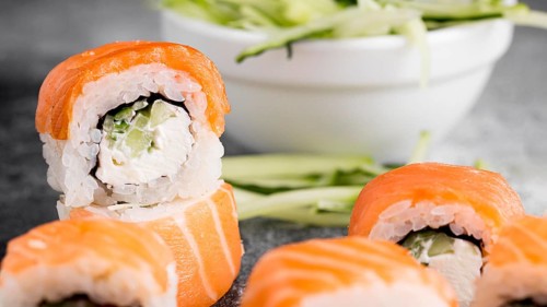 Salad fresh sushi rolls close up