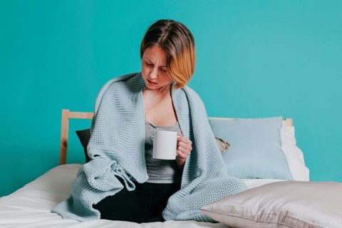 Sick woman with cup bed