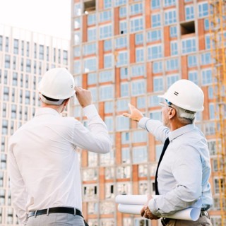Side view man pointing building scaffolding