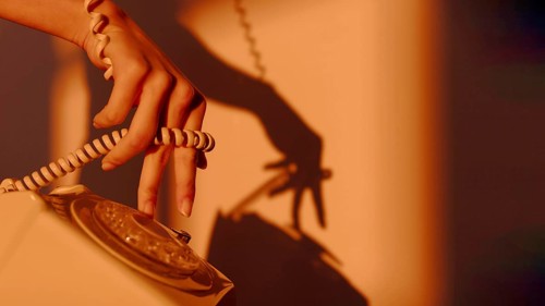 Silhouette woman using telephone