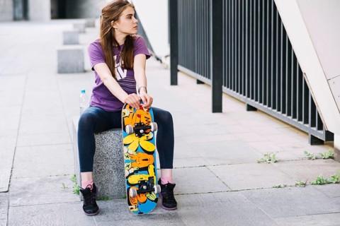 Skateboarder girl looking left