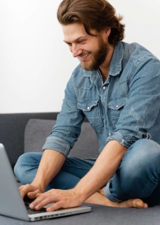Smiley man typing laptop s keyboard