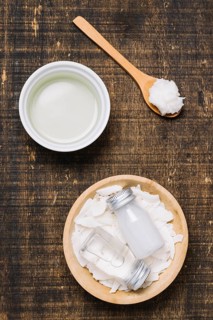 Spoonfull with bowls coconut oil top view