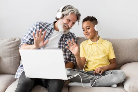 Student teacher waving laptop