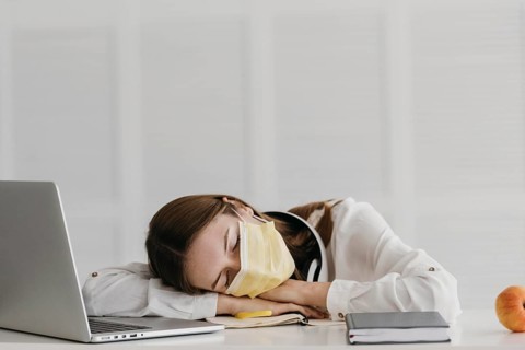 Student wearing medical mask sleeping