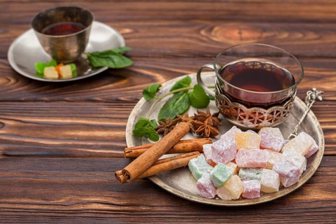 Tea cup with turkish delight wooden table