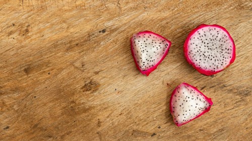 Top view dragon fruit with wooden background