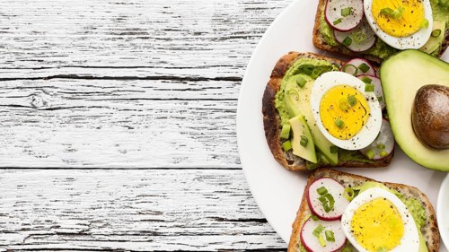 Top view egg avocado sandwiches plate with copy space
