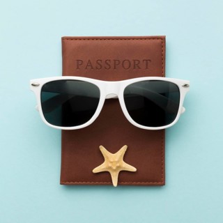 Top view summer glasses with passport