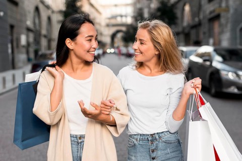 Two women out city going shopping spree