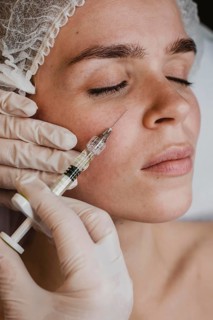 Woman getting facial beauty treatment wellness center