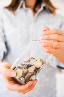 Woman holding jar with money