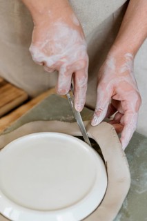 Woman making clay pot her workshop