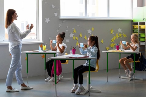 Woman teaching kids how use medical mask