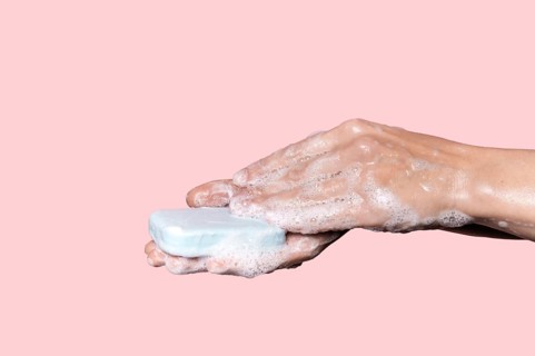 Woman washing hands with blue soap