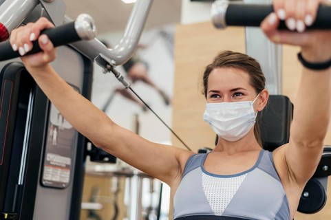 Woman working out gym during pandemic