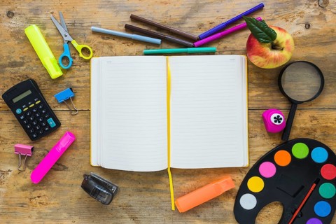 Writing implements apple laid circle with notebook middle