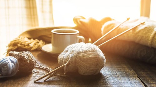 Yarn needles near hot beverage