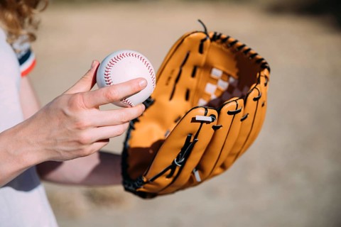 Young woman with baseball glove