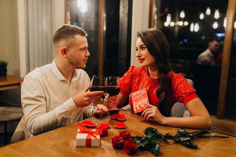Adorable loving couple with wine cafe
