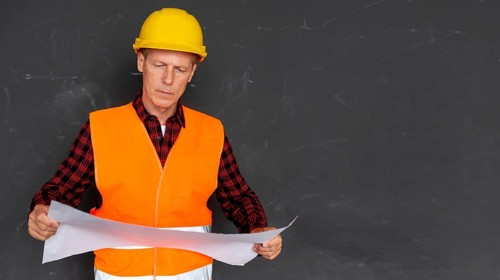 Architect checking plans with copy space