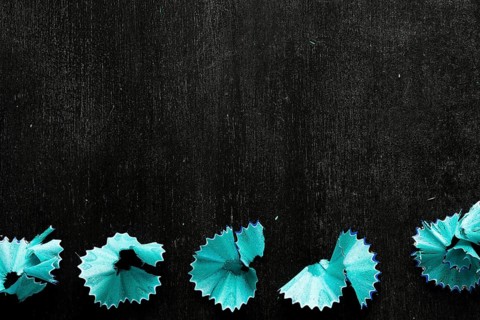 Blue pencil chips black desk