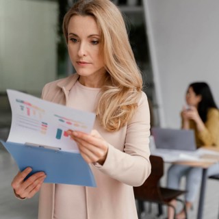 Businesswoman looking through infographics