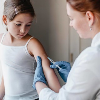 Child doctor getting vaccine