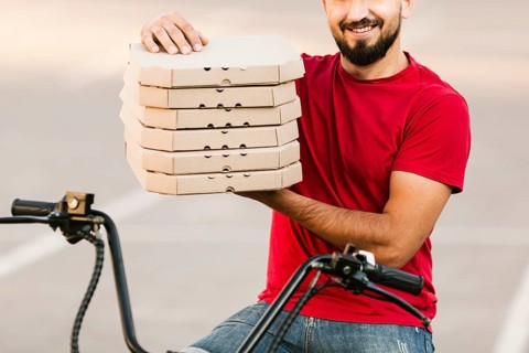 Close up delivery man holding pizza boxes