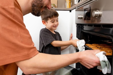 Close up father boy baking