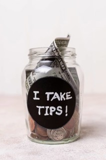 Close up glass with money as tips